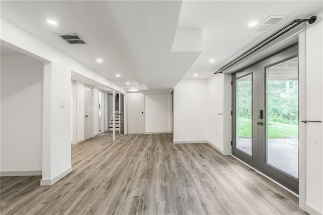 10908 Indiana Ave, Kansas City, MO 64137 - basement with light wood-style flooring, baseboards, recessed lighting, french doors, and stairway