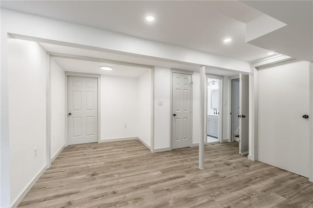 10908 Indiana Ave, Kansas City, MO 64137 - finished below grade area featuring light wood-style floors, recessed lighting, and baseboards