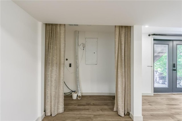 10908 Indiana Ave, Kansas City, MO 64137 - hall featuring french doors, wood finished floors, electric panel, and baseboards