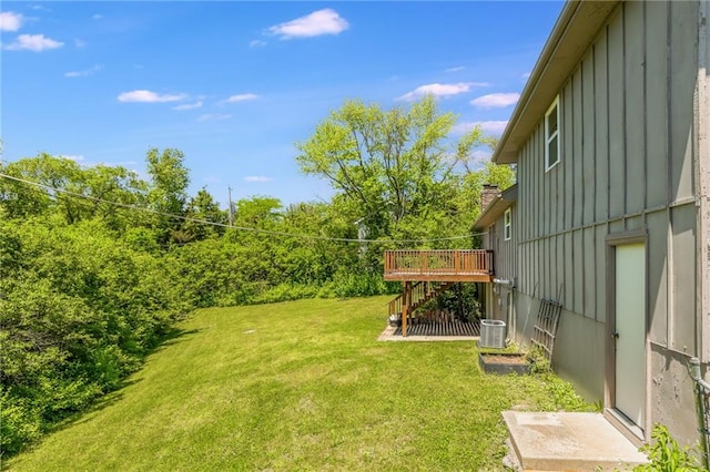 10908 Indiana Ave, Kansas City, MO 64137 - view of grassy yard featuring stairs, a wooden deck, and cooling unit