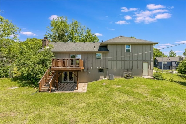 10908 Indiana Ave, Kansas City, MO 64137 - back of property featuring stairs, a wooden deck, a chimney, board and batten siding, and a patio area