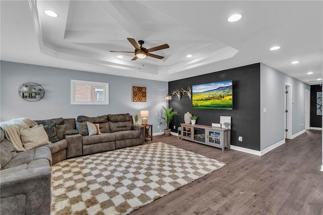 807 N Main St, Carrollton, MO 64633 - living area featuring a raised ceiling, ceiling fan, wood finished floors, baseboards, and recessed lighting