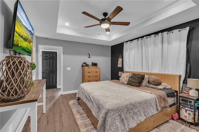 807 N Main St, Carrollton, MO 64633 - bedroom with a raised ceiling, wood finished floors, recessed lighting, ornamental molding, and ceiling fan