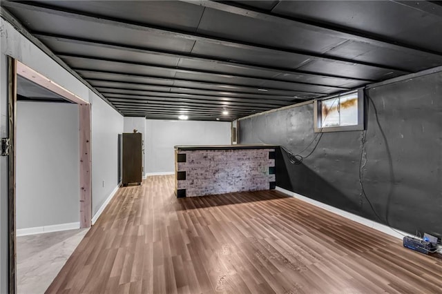 807 N Main St, Carrollton, MO 64633 - below grade area with a dry bar, wood finished floors, and baseboards