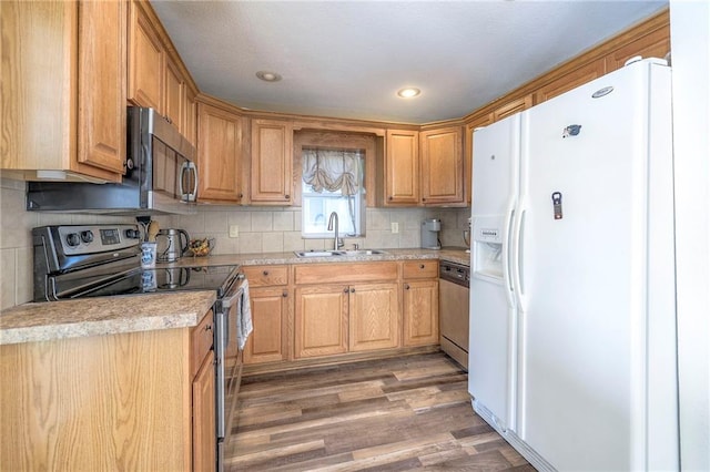 1101 S Independence St, Harrisonville, MO 64701 - kitchen featuring appliances with stainless steel finishes, a sink, light wood-type flooring, light countertops, and recessed lighting