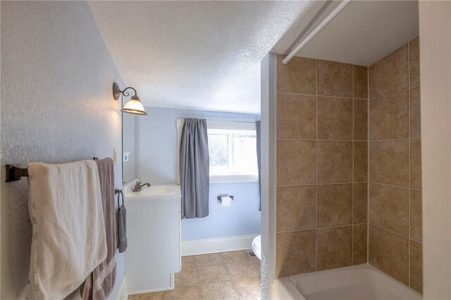 1101 S Independence St, Harrisonville, MO 64701 - full bathroom with vanity, toilet, shower / tub combination, and a textured ceiling