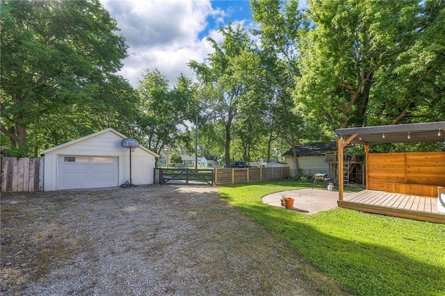 1101 S Independence St, Harrisonville, MO 64701 - view of yard with a garage, a wooden deck, gravel driveway, and an outbuilding