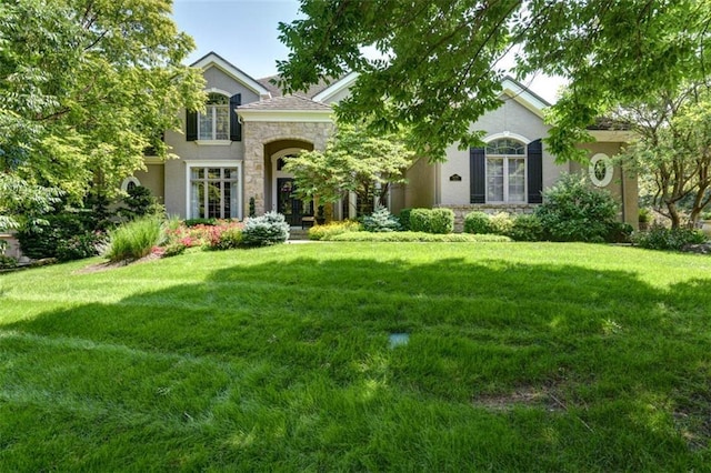 14301 Briar St, Leawood, KS 66224 - view of front of home with stone siding, stucco siding, and a front yard