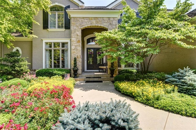 14301 Briar St, Leawood, KS 66224 - view of exterior entry with stone siding, french doors, and stucco siding