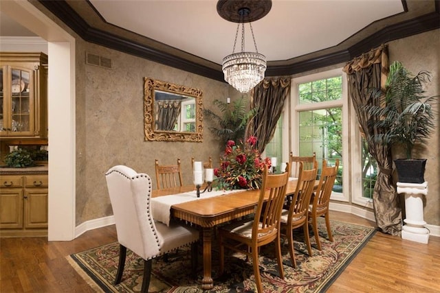 14301 Briar St, Leawood, KS 66224 - dining space featuring ornamental molding, wood finished floors, and a chandelier