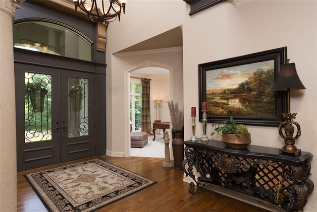 14301 Briar St, Leawood, KS 66224 - entrance foyer with arched walkways, french doors, crown molding, and wood finished floors
