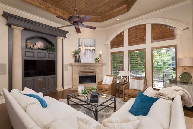 14301 Briar St, Leawood, KS 66224 - living area featuring a ceiling fan, a raised ceiling, wood finished floors, a fireplace, and wood ceiling