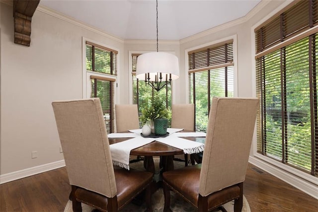 14301 Briar St, Leawood, KS 66224 - dining room with healthy amount of natural light, dark wood-style flooring, crown molding, and a chandelier