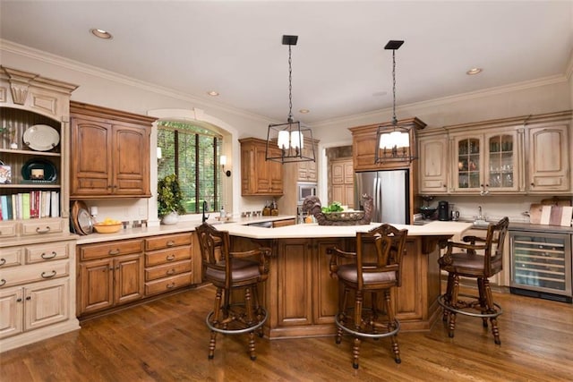 14301 Briar St, Leawood, KS 66224 - kitchen with stainless steel appliances, wine cooler, light countertops, dark wood finished floors, and a center island