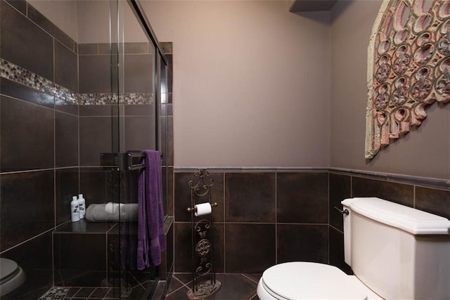 14301 Briar St, Leawood, KS 66224 - full bathroom featuring tile walls, a shower stall, and a wainscoted wall