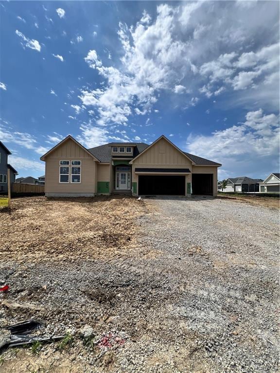 16500 Ingalls St, Gardner, KS 66030 - view of front of home featuring a garage, driveway, and board and batten siding