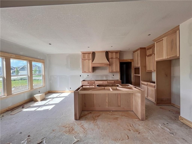 16500 Ingalls St, Gardner, KS 66030 - kitchen with a center island, custom range hood, a textured ceiling, and light brown cabinetry