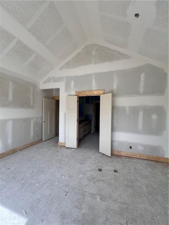 16500 Ingalls St, Gardner, KS 66030 - unfurnished living room featuring lofted ceiling and baseboards