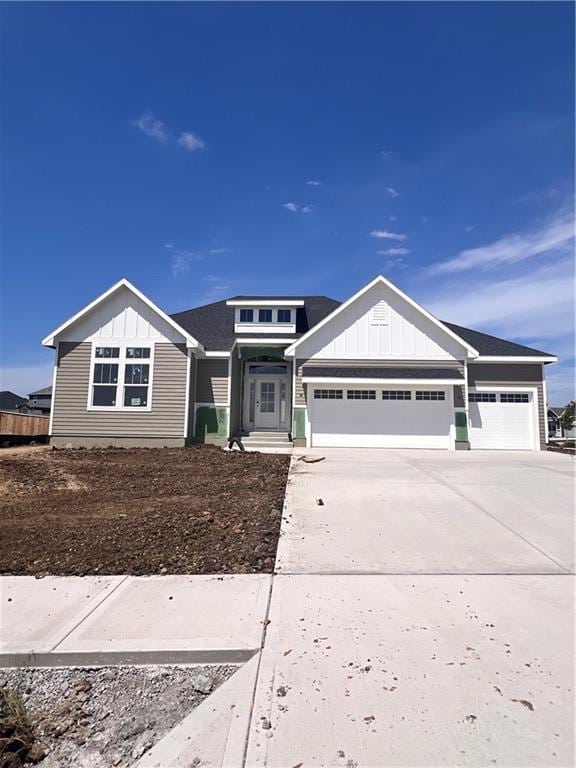 16500 Ingalls St, Gardner, KS 66030 - view of front facade with board and batten siding, a garage, and driveway