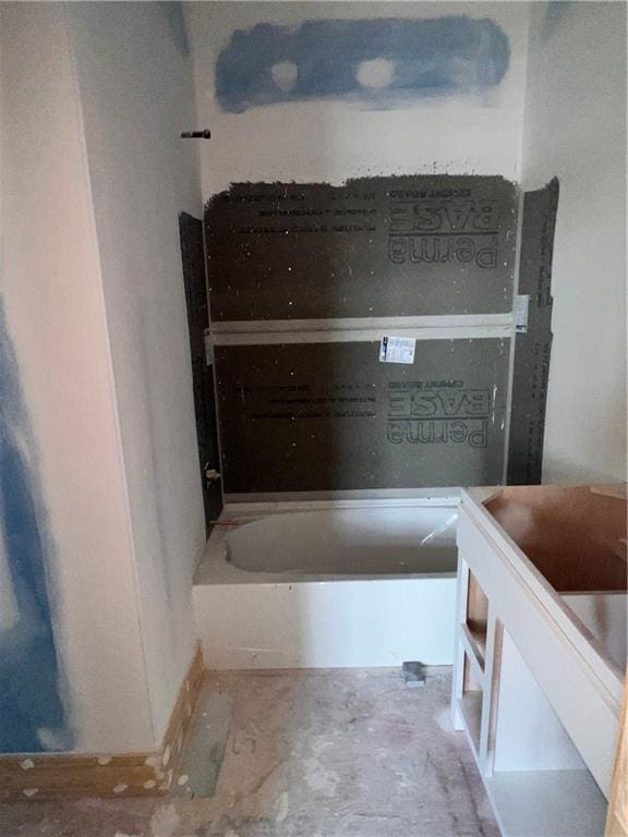 16500 Ingalls St, Gardner, KS 66030 - full bath featuring vanity, a tub to relax in, and unfinished concrete flooring