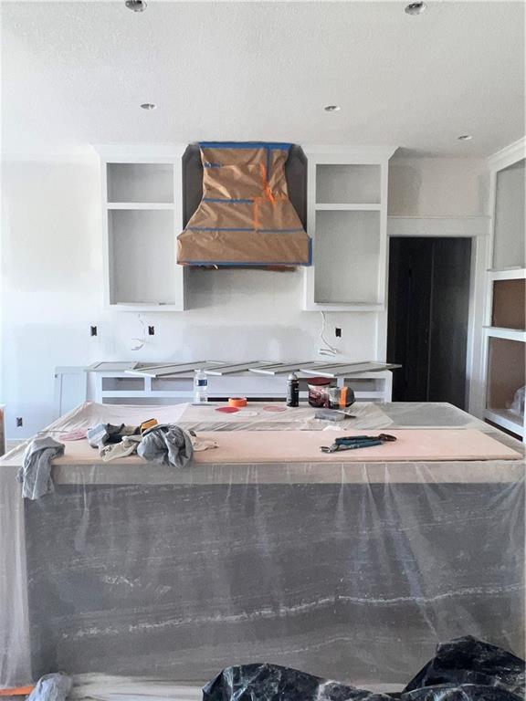 16500 Ingalls St, Gardner, KS 66030 - kitchen with wall chimney exhaust hood, open shelves, and a center island