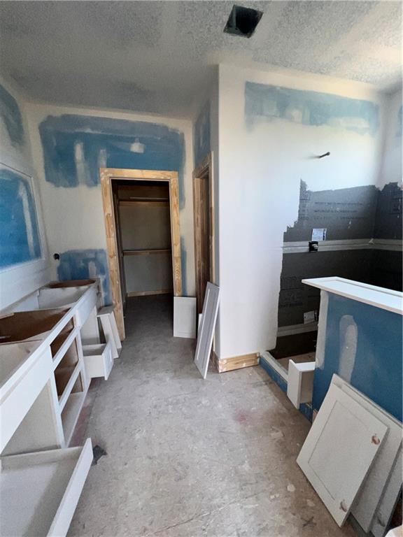 16500 Ingalls St, Gardner, KS 66030 - kitchen featuring a textured ceiling and concrete flooring