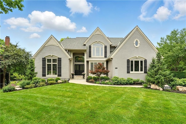 13905 Lucille St, Overland Park, KS 66221 - view of front facade with a front yard and stucco siding