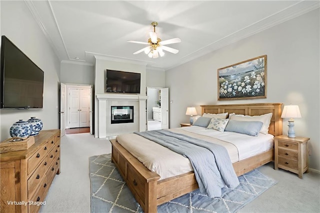 13905 Lucille St, Overland Park, KS 66221 - bedroom with carpet flooring, ornamental molding, a glass covered fireplace, and ceiling fan