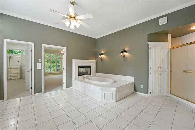 13905 Lucille St, Overland Park, KS 66221 - bathroom with tile patterned floors, a bath, crown molding, ceiling fan, and a glass covered fireplace