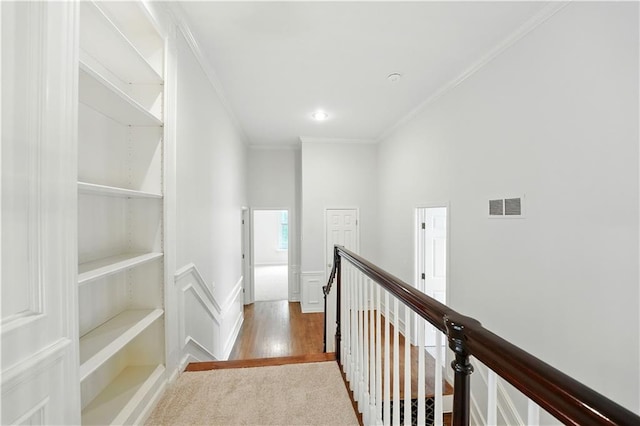 13905 Lucille St, Overland Park, KS 66221 - corridor with an upstairs landing, crown molding, wood finished floors, and a wainscoted wall