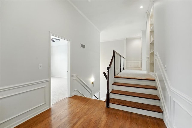 13905 Lucille St, Overland Park, KS 66221 - stairs with ornamental molding, a decorative wall, wood finished floors, and recessed lighting