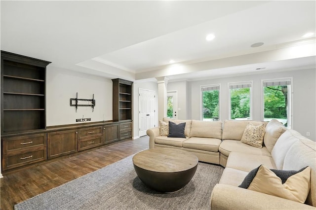13905 Lucille St, Overland Park, KS 66221 - living area featuring ornate columns, ornamental molding, dark wood finished floors, recessed lighting, and a tray ceiling