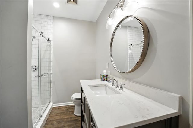 13905 Lucille St, Overland Park, KS 66221 - bathroom with a shower stall, vanity, wood finished floors, and recessed lighting