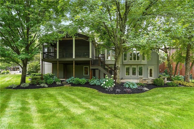 13905 Lucille St, Overland Park, KS 66221 - back of property featuring a sunroom, stairway, and a lawn