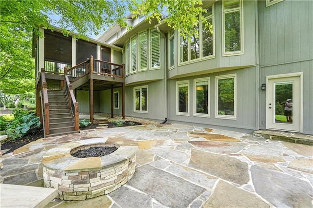 13905 Lucille St, Overland Park, KS 66221 - back of house with a fire pit, stairs, a patio area, and a wooden deck