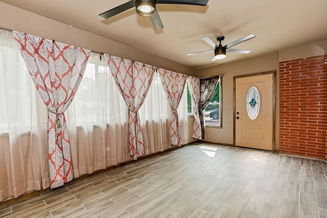 1036 Vilas St, Leavenworth, KS 66048 - empty room featuring a ceiling fan, wood finished floors, and brick wall
