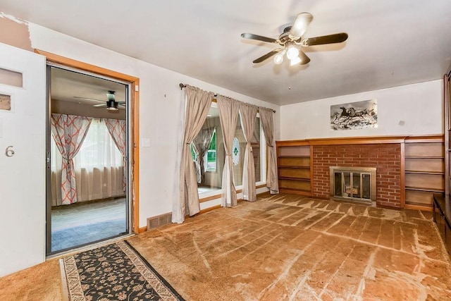 1036 Vilas St, Leavenworth, KS 66048 - unfurnished living room with a ceiling fan, carpet floors, and a brick fireplace