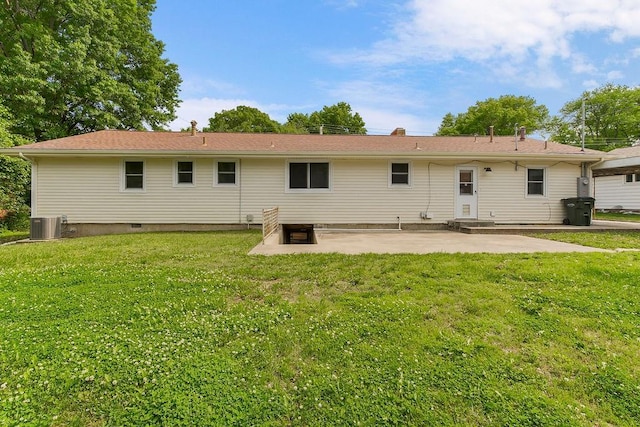 1036 Vilas St, Leavenworth, KS 66048 - back of property featuring a patio, a lawn, and central AC unit