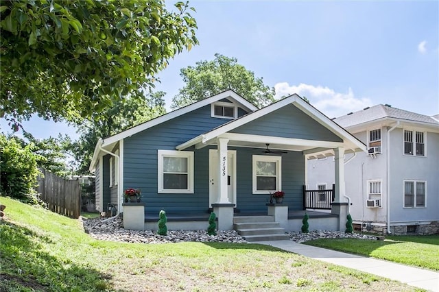 5135 Tracy Ave, Kansas City, MO 64110 - bungalow-style home featuring covered porch, ceiling fan, and cooling unit