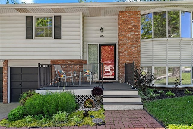 522 Kasold Dr, Lawrence, KS 66049 - property entrance featuring brick siding, a porch, and an attached garage