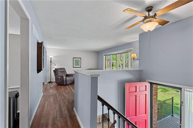 522 Kasold Dr, Lawrence, KS 66049 - hallway featuring an upstairs landing, dark wood-style floors, and baseboards