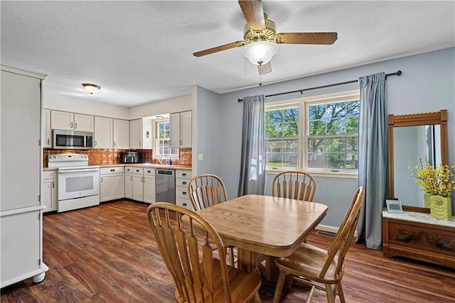 522 Kasold Dr, Lawrence, KS 66049 - dining area featuring dark wood-type flooring and a ceiling fan
