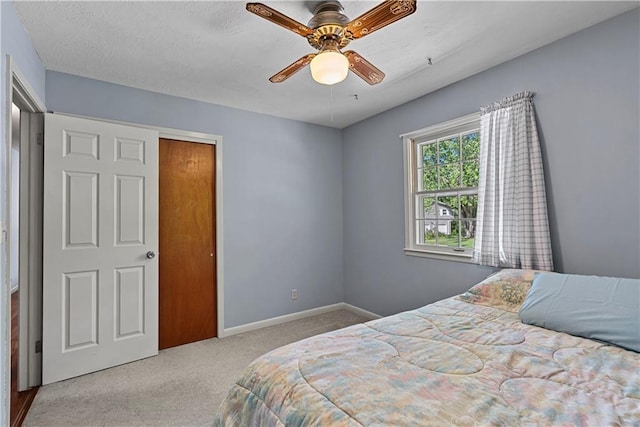 522 Kasold Dr, Lawrence, KS 66049 - carpeted bedroom with baseboards and a ceiling fan