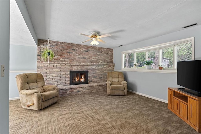 522 Kasold Dr, Lawrence, KS 66049 - carpeted living area with ceiling fan, baseboards, a fireplace, and a textured ceiling