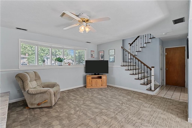 522 Kasold Dr, Lawrence, KS 66049 - living area with stairs, healthy amount of natural light, a ceiling fan, and baseboards