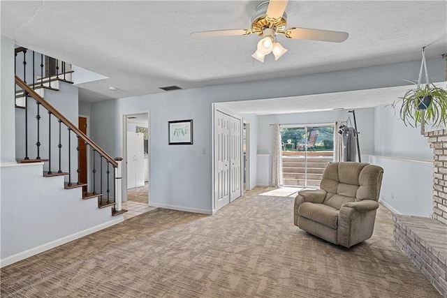 522 Kasold Dr, Lawrence, KS 66049 - sitting room featuring stairs, carpet floors, ceiling fan, a textured ceiling, and baseboards
