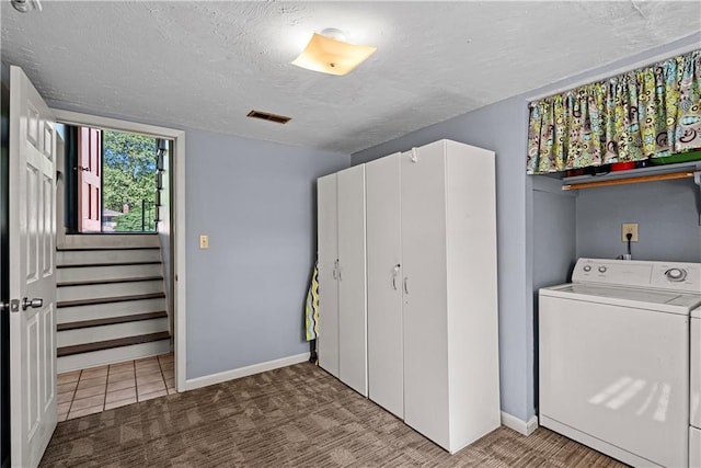 522 Kasold Dr, Lawrence, KS 66049 - laundry area with washer / dryer, baseboards, a textured ceiling, and carpet flooring