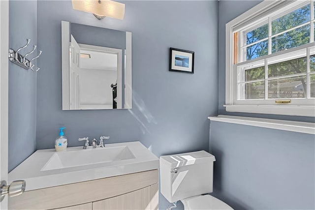 522 Kasold Dr, Lawrence, KS 66049 - half bathroom with healthy amount of natural light, vanity, and toilet