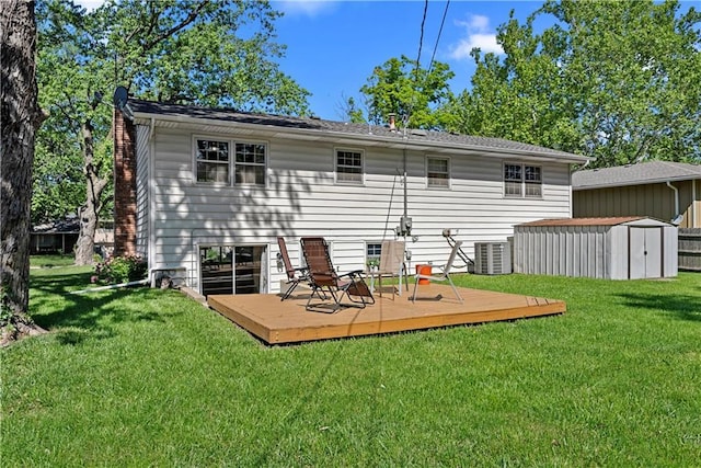 522 Kasold Dr, Lawrence, KS 66049 - rear view of property with a wooden deck, a lawn, a chimney, and central AC