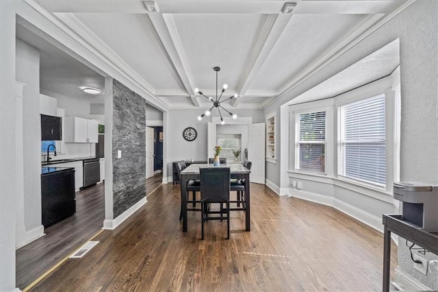 1316 E 42nd St, Kansas City, MO 64110 - dining room featuring a chandelier, beamed ceiling, dark wood-style floors, baseboards, and crown molding